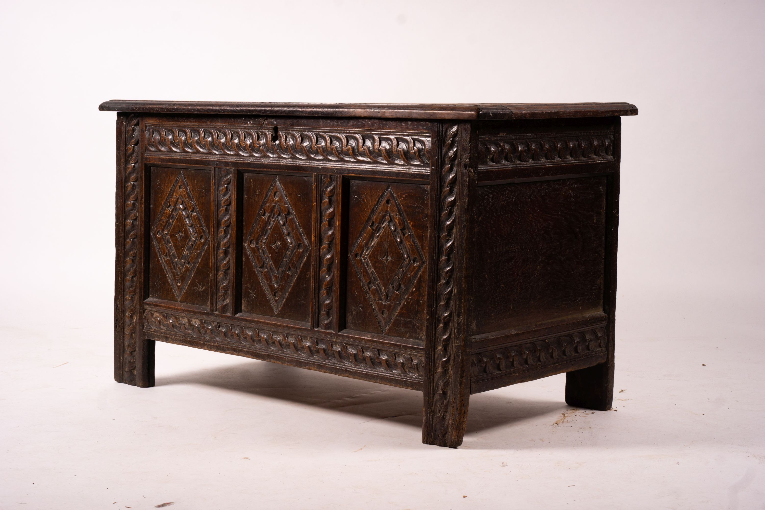 A 17th century carved panelled oak coffer, length 115cm, depth 56cm, height 67cm